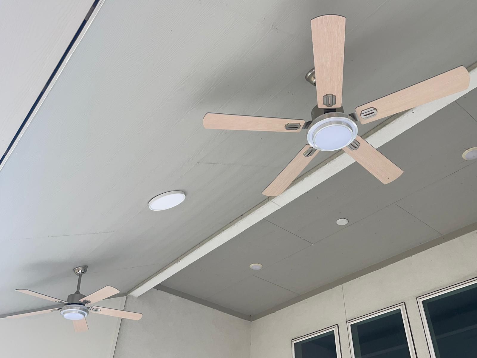 A ceiling fan is hanging from the ceiling of a room.