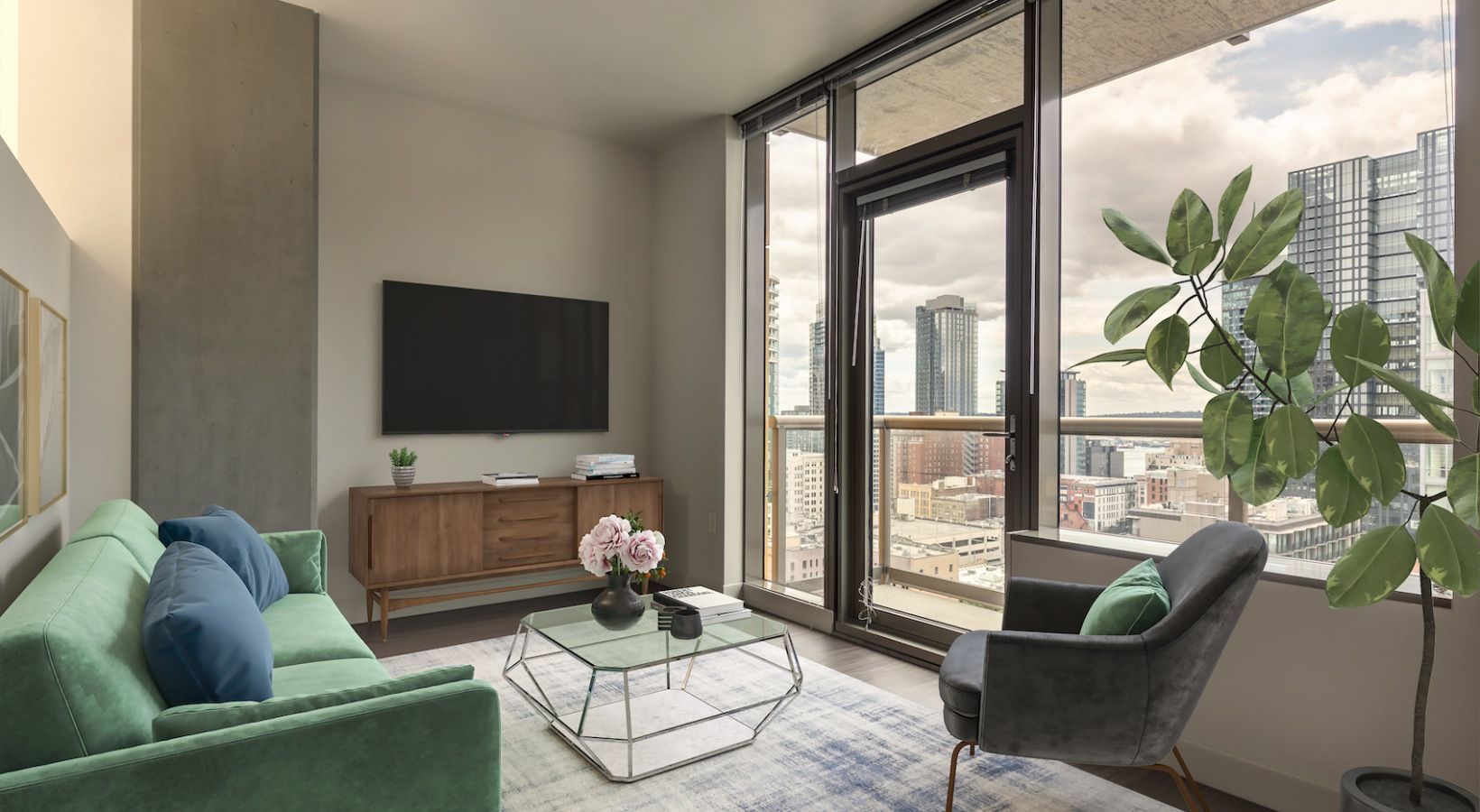 Living room in a modern apartment with a green sofa, glass coffee table, and city-view balcony.