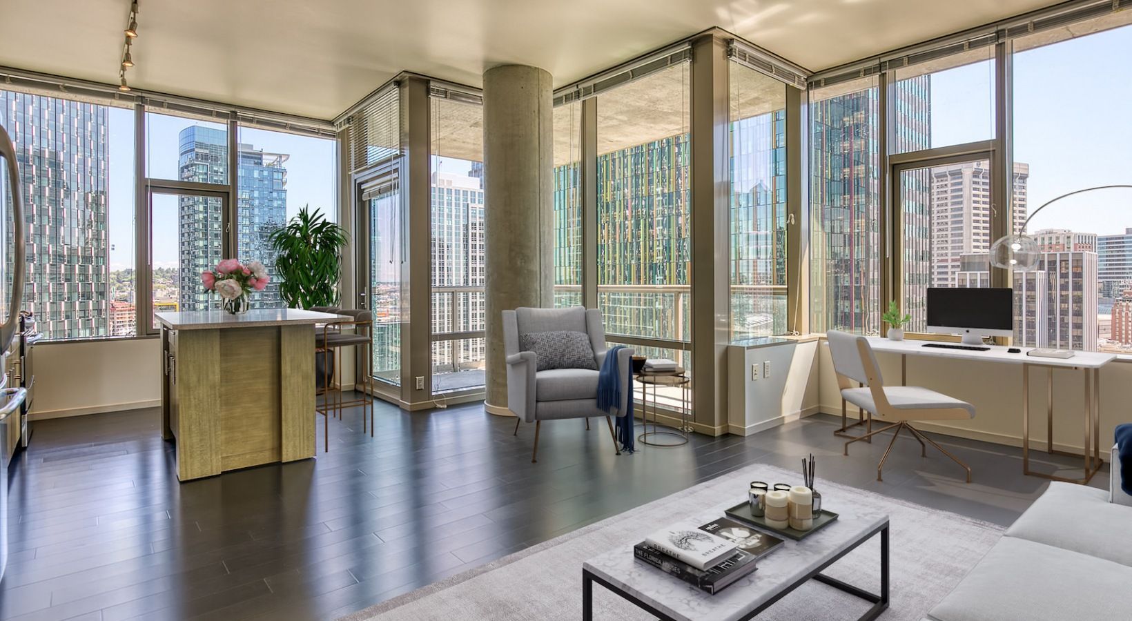 Bright modern apartment living area with large windows and city skyline view.