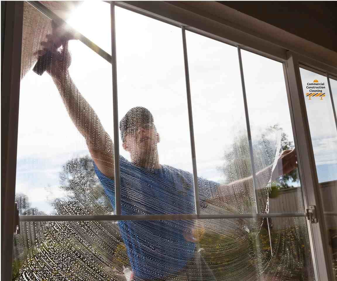 A man wiping clean a window
