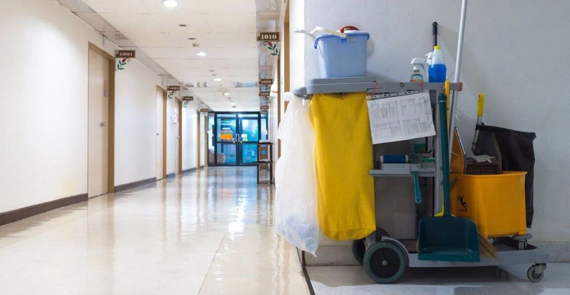 A cleaning cart in a hospital hallway
