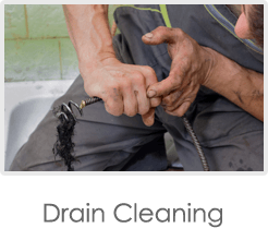 Man Cleaning the drain — Plumbing Repair in Horse Prairie, RD
