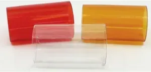 Three translucent, cylindrical plastic sleeves in red, clear, and amber, arranged on a white surface.
