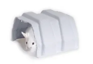 A white hamster peeking out from under a small, white, molded plastic archway shelter.