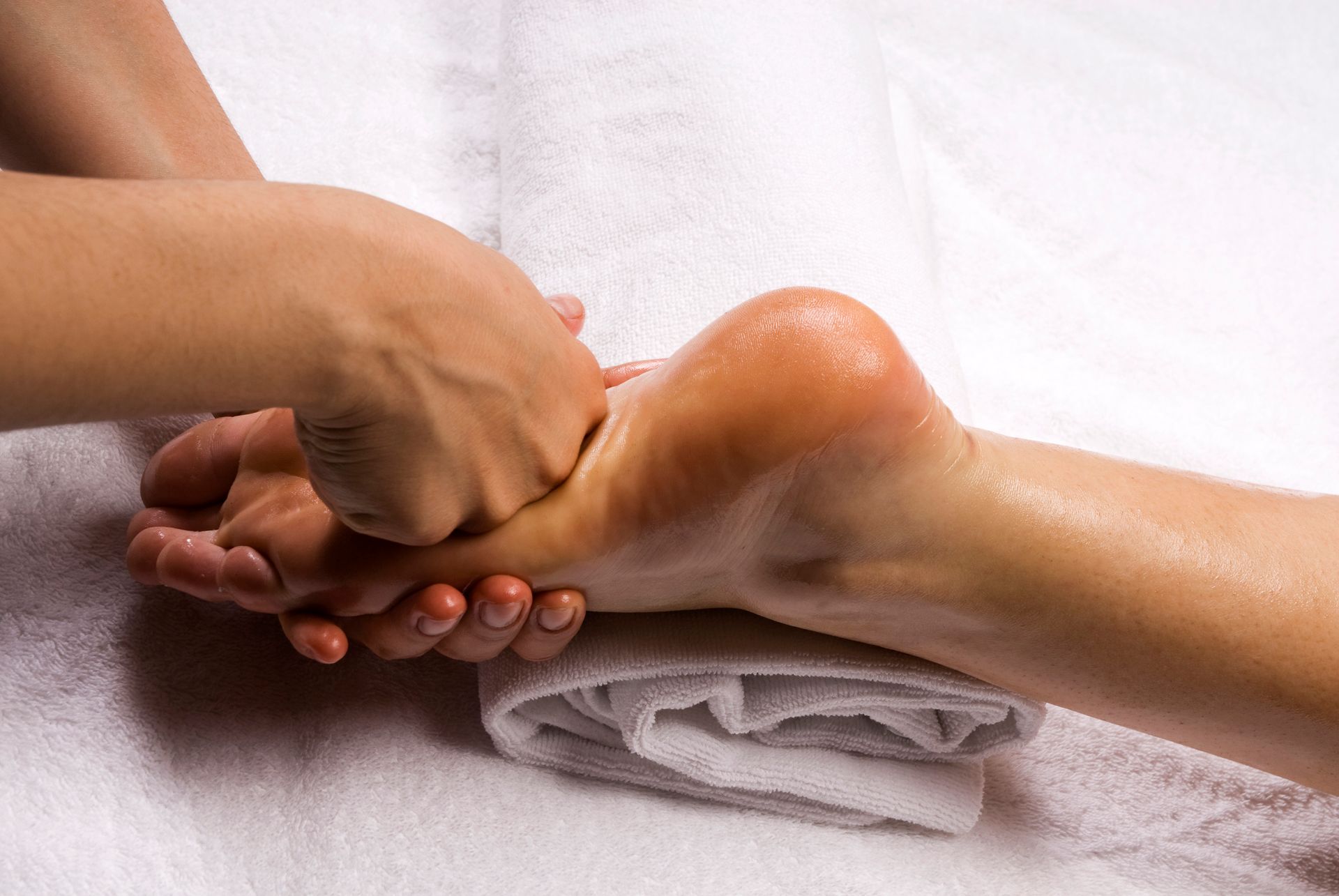 A Woman Is Getting A Foot Press Massage — Wilmington, NC — Mystic Massage