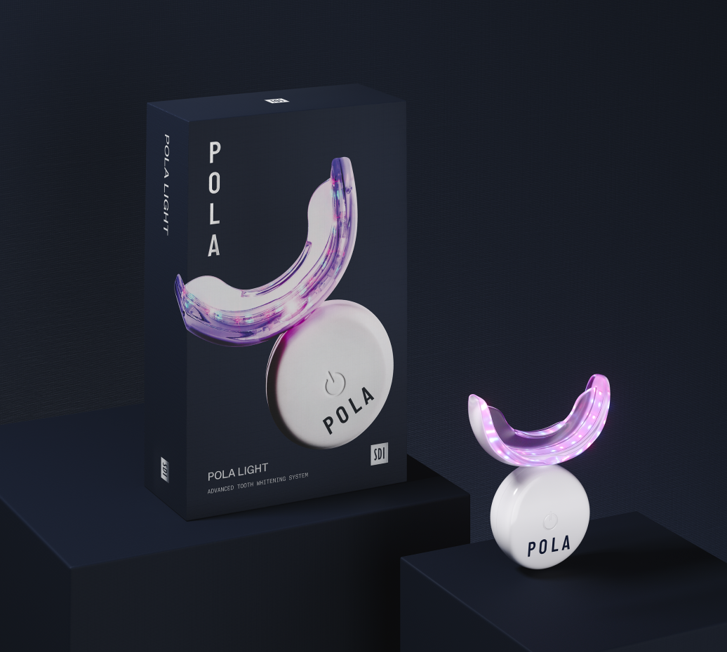 Dental tools and whitening kit on blue cloth; clinic setting.