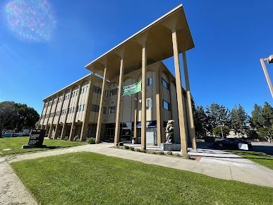 Dental exam room with chair, equipment, and wall-mounted TV.