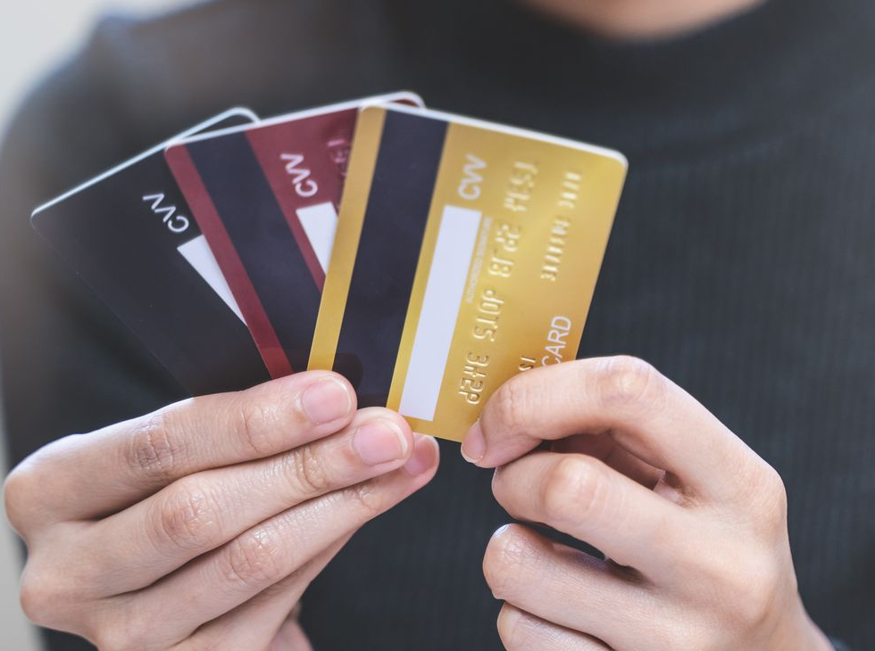 Balloons of varying blue hues surround a wall with logo that says 