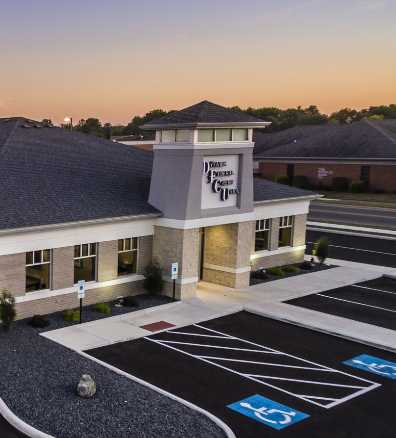 DFC Federal Credit Union building with gray roof and blue sky.