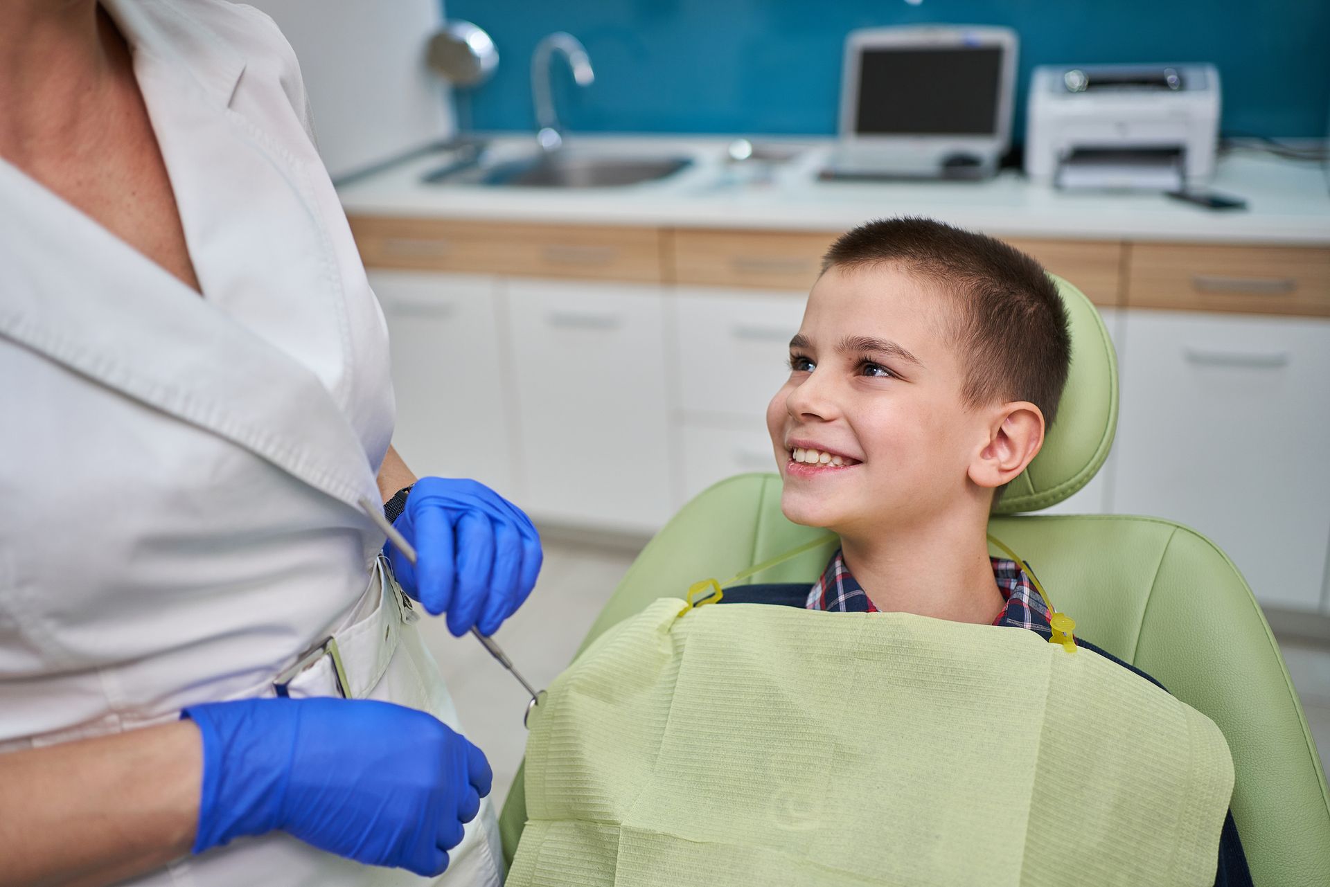A Boy Seated In A Dentist Chair - Las Vegas, NV - Corona Dental