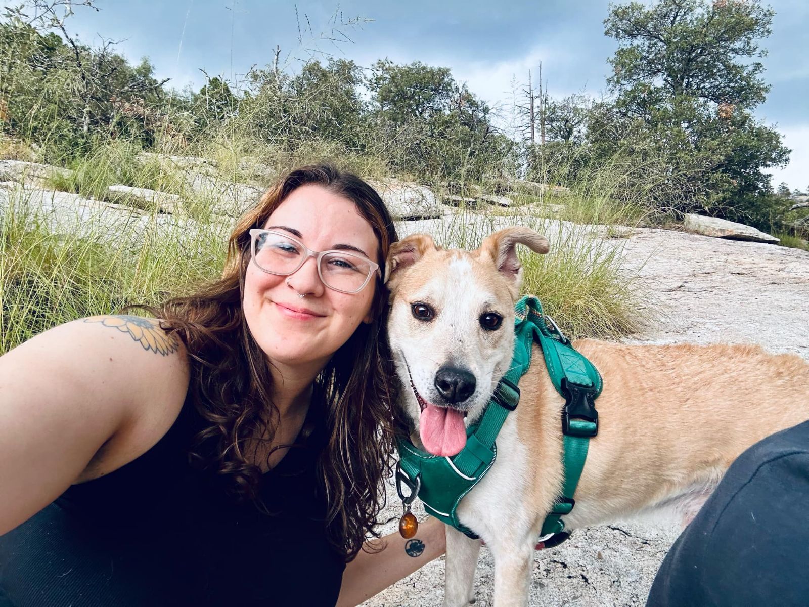 A woman is posing for a picture with her dog.
