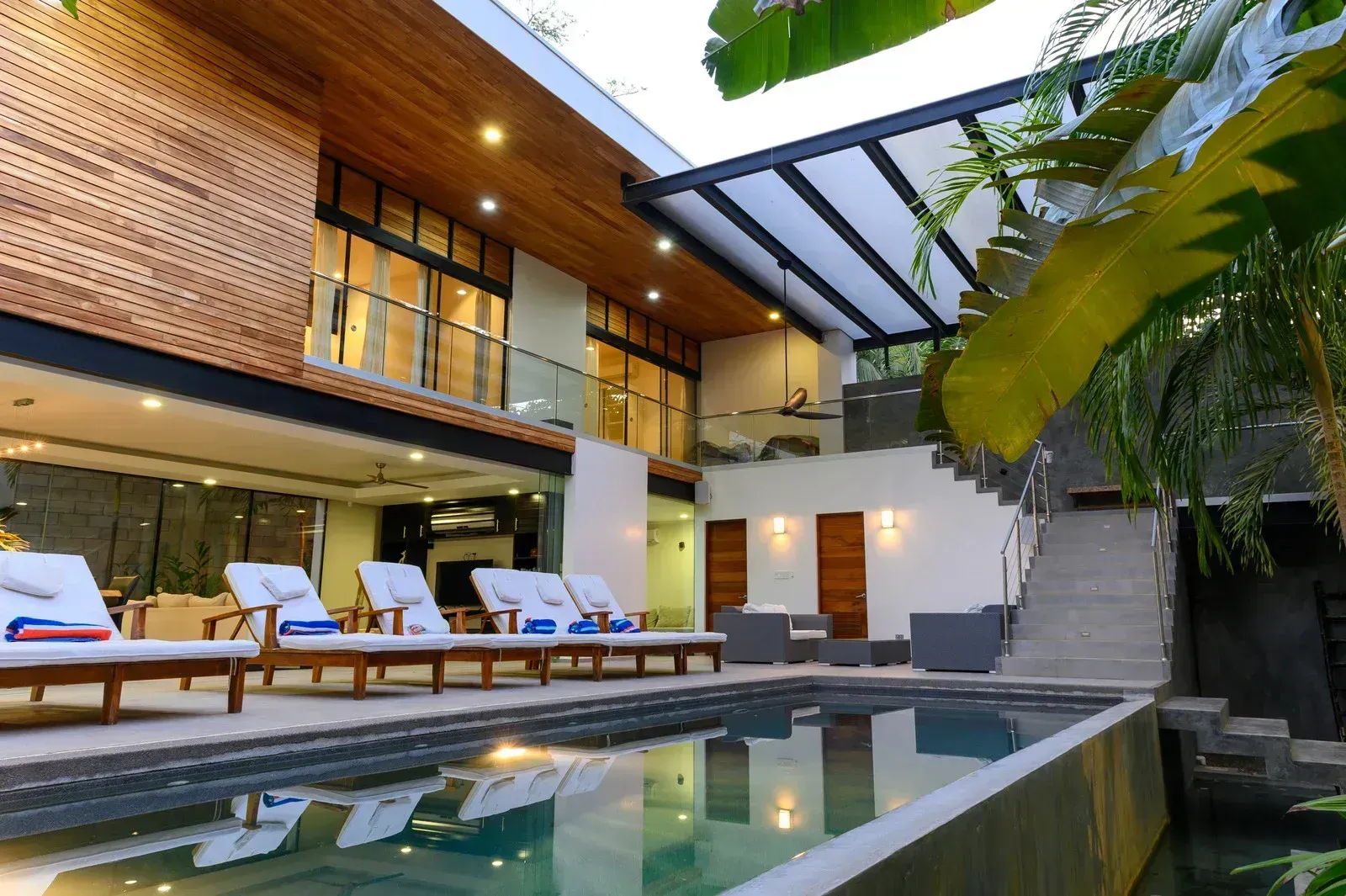 A large house with a swimming pool in front of it