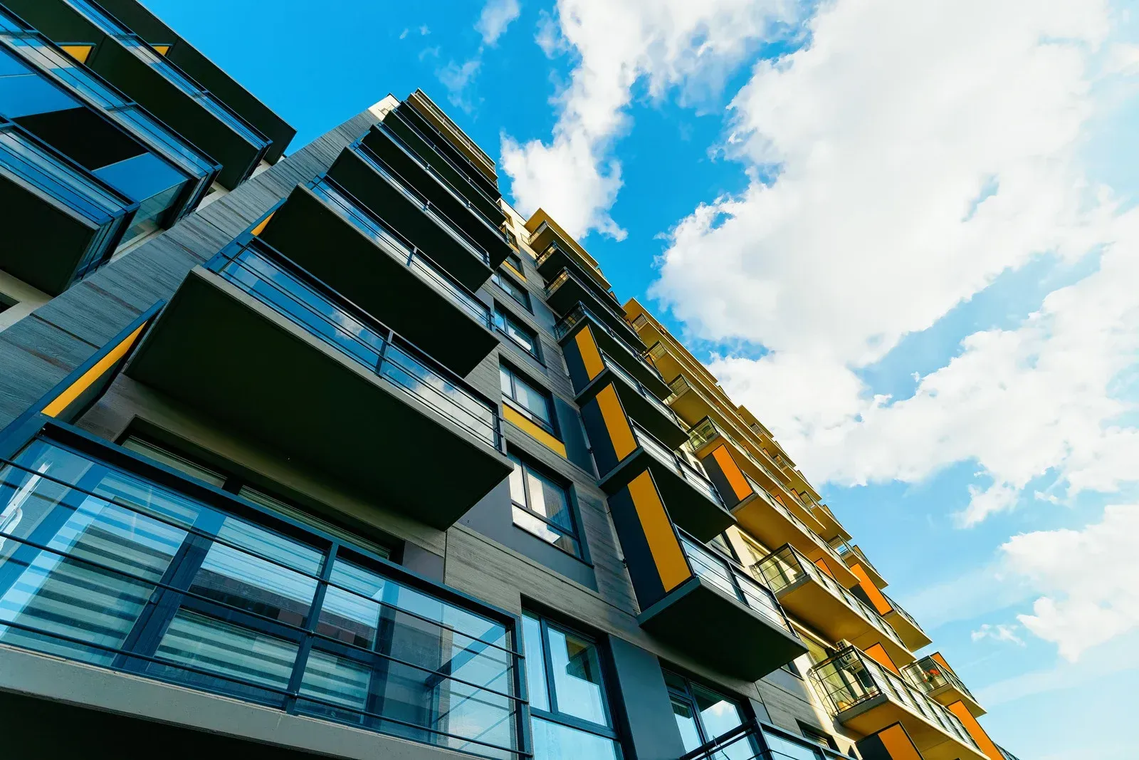 Looking up at a tall building with a blue sky in the background.