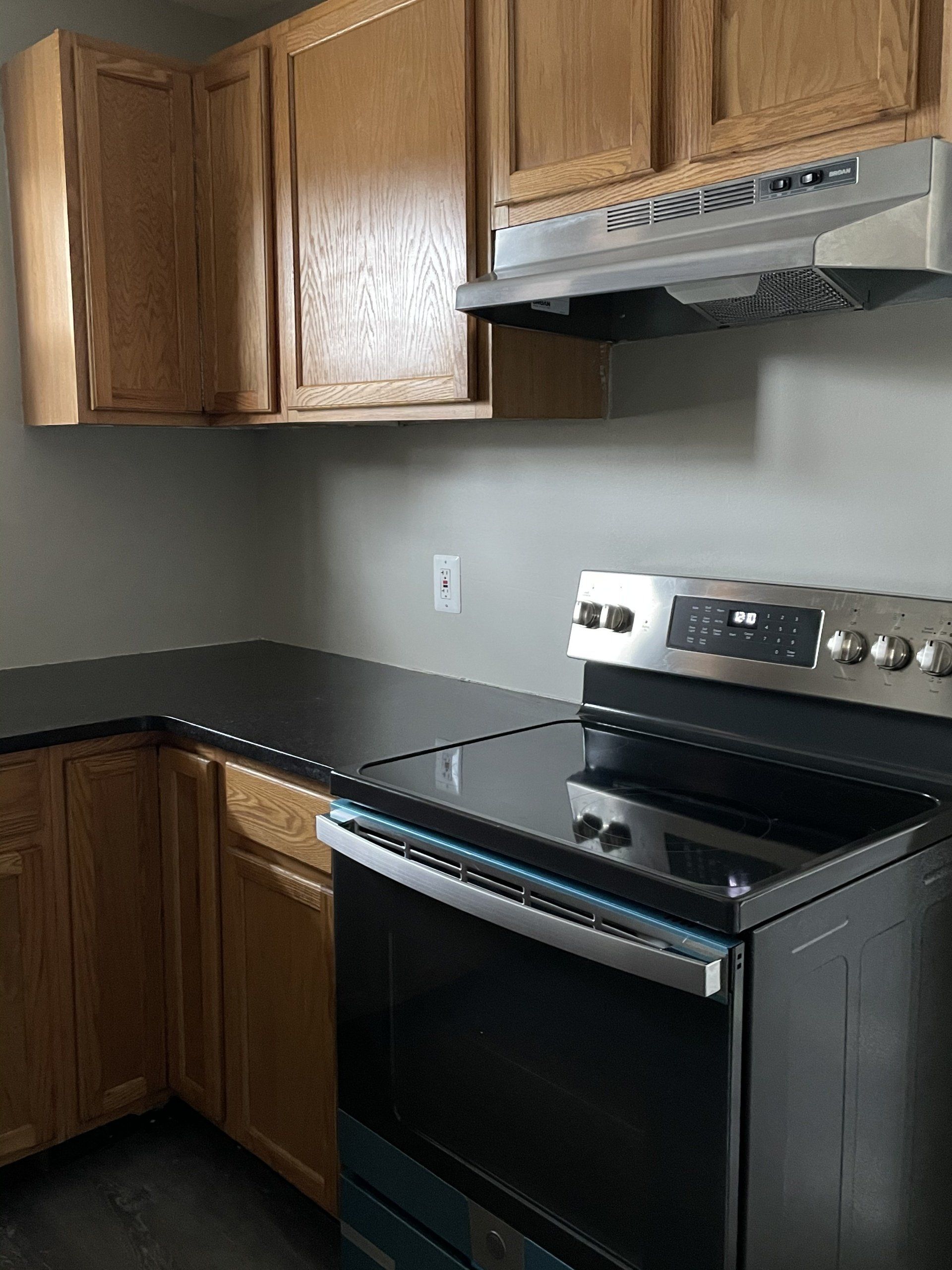 stove and oven with black countertops