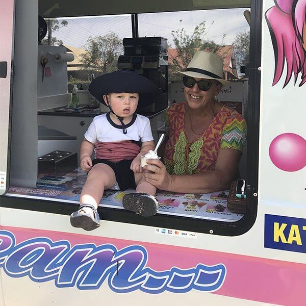 Ice Cream Vendor & Child Eating Ice Cream — Mrs. Softy Ice Cream in Dubbo, NSW