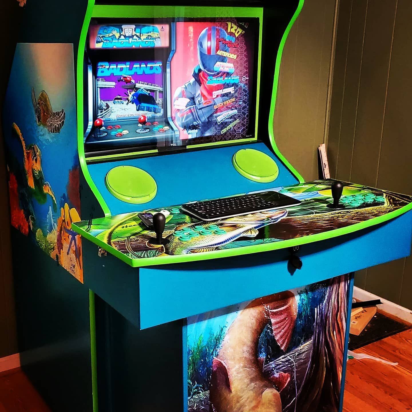 G&G Arcade Custom Cabinets | a blue and green arcade machine with a game on the screen