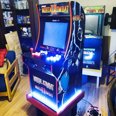 G&G Arcade Custom Cabinets | a video game called mortal kombat sits in a living room