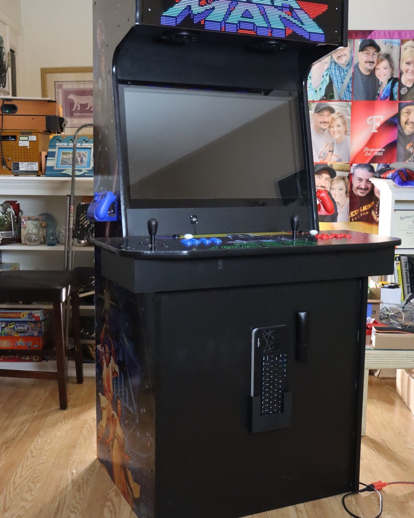 G&G Arcade Custom Cabinets | a black arcade machine is sitting in a living room