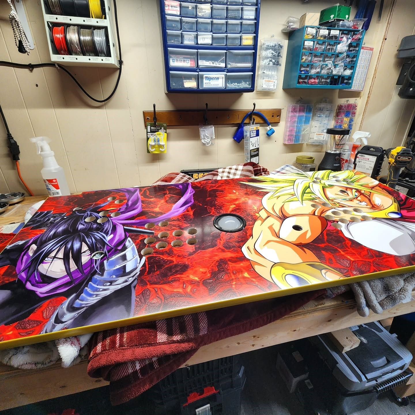 G&G Arcade Custom Cabinets | a table with a painting of a man and a woman on it