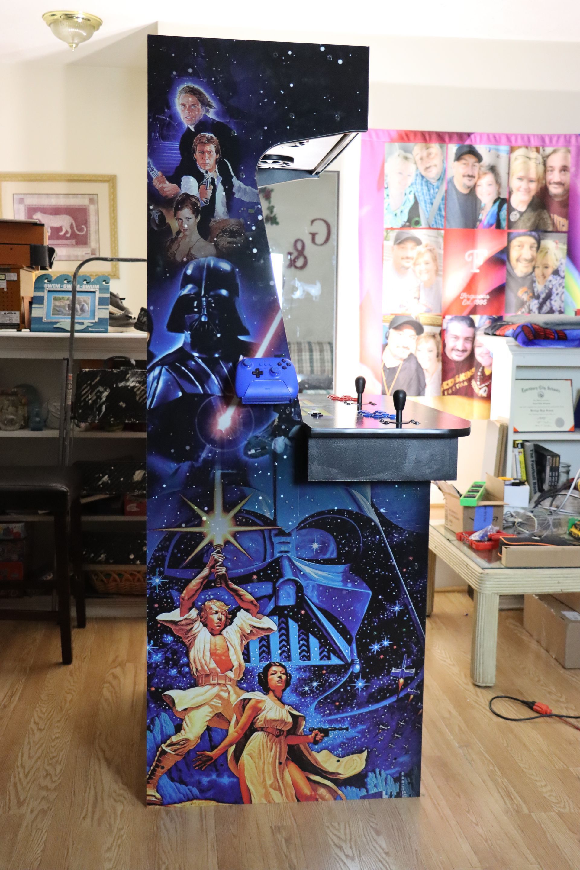 A star wars arcade machine is sitting in a living room.