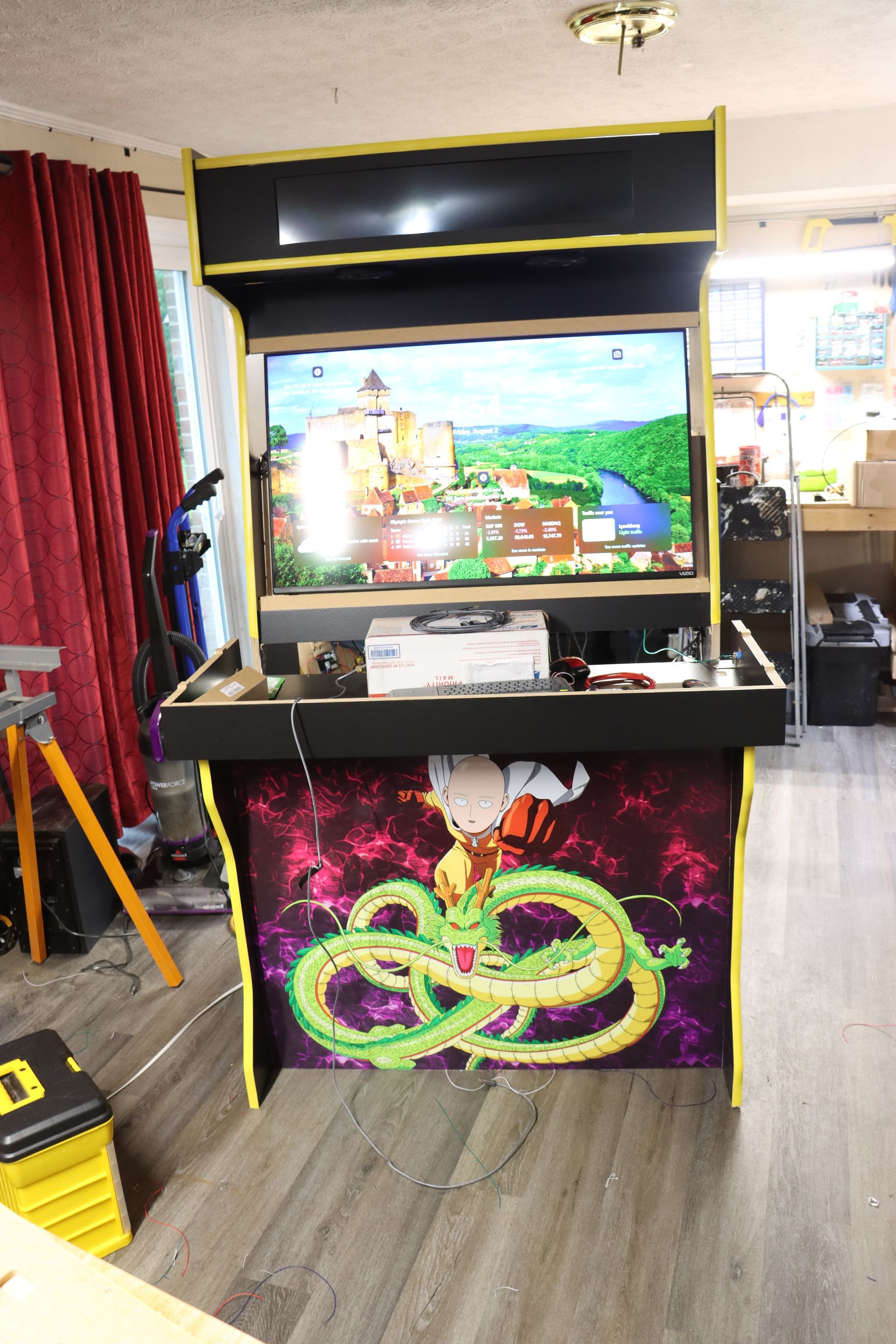 A video game arcade with a dragon ball z game on the screen.