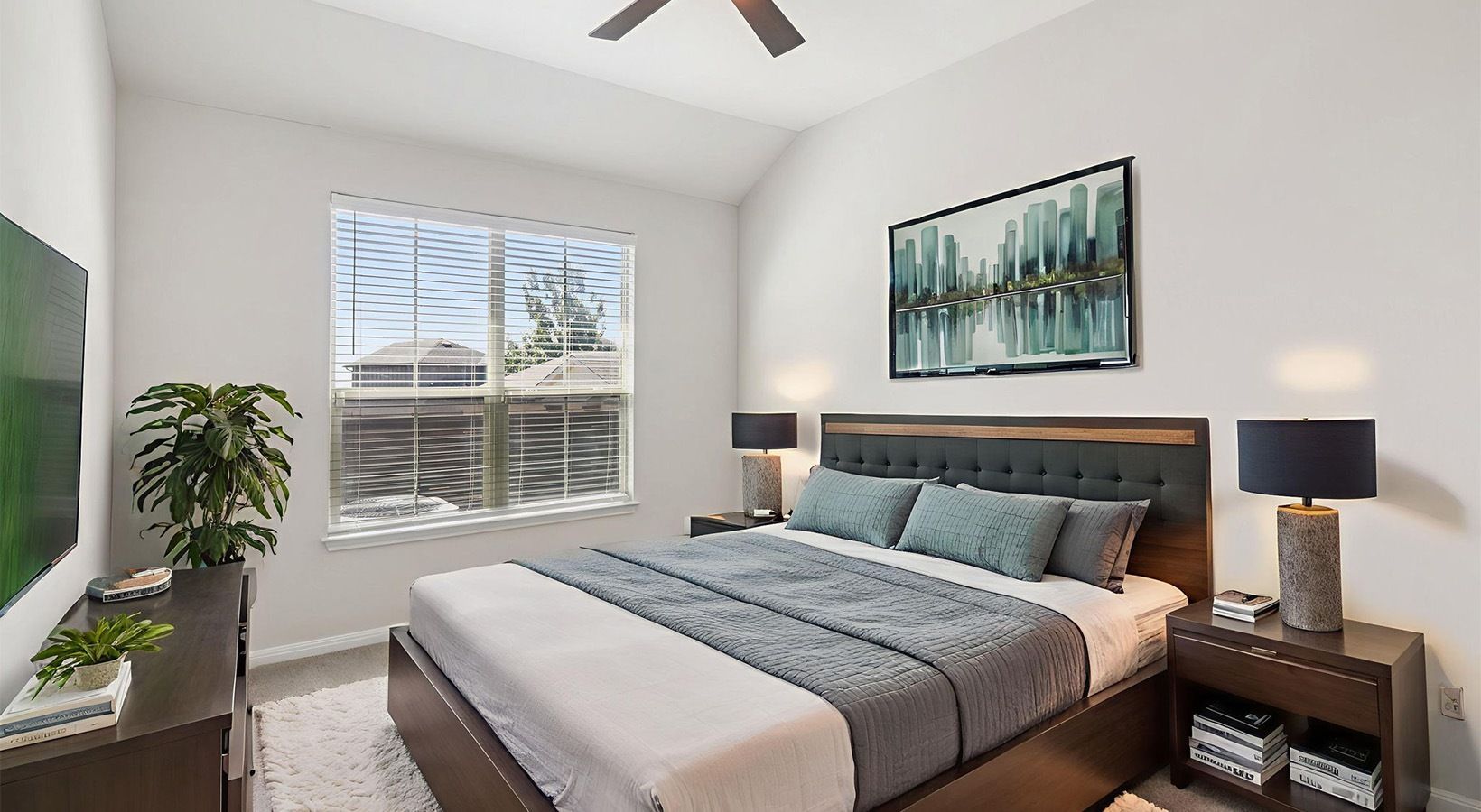 Bright bedroom in a modern apartment with a large window, bed, and nightstands.