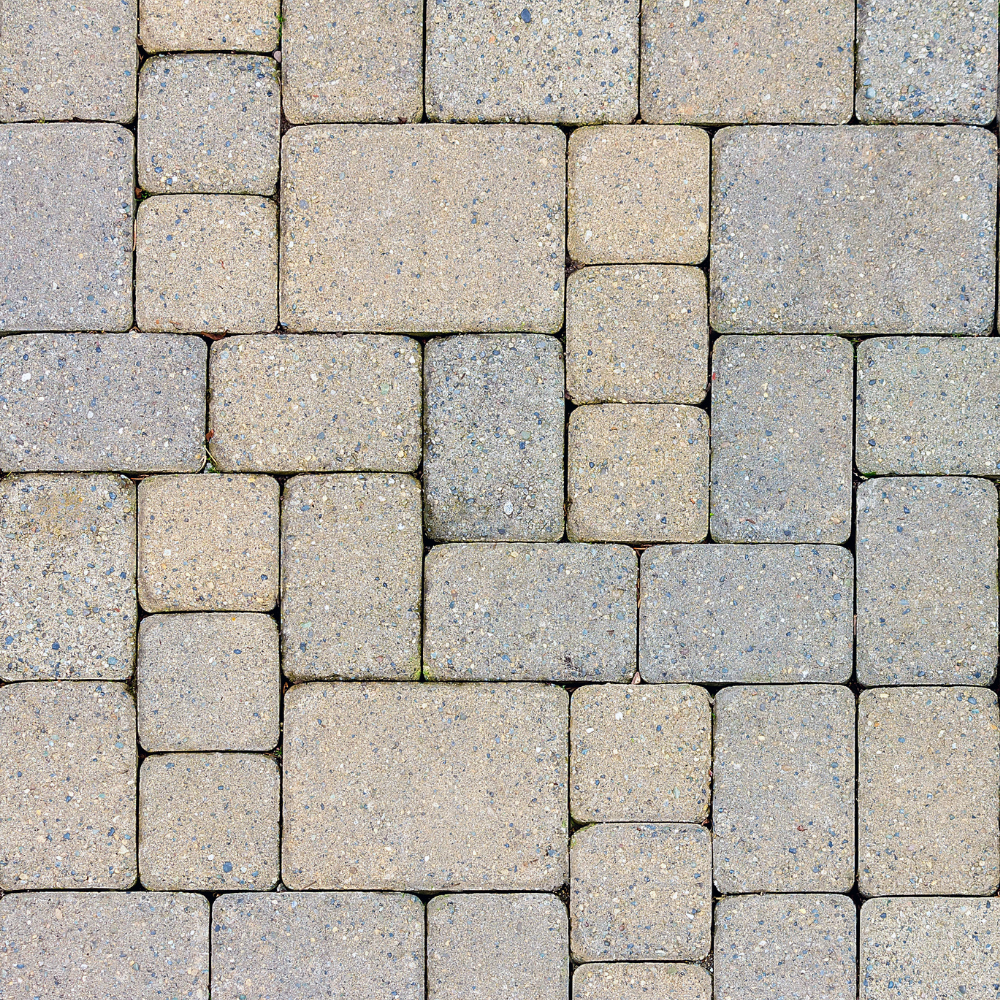 Close-up view of interlocking paving stones in tan and gray colors.