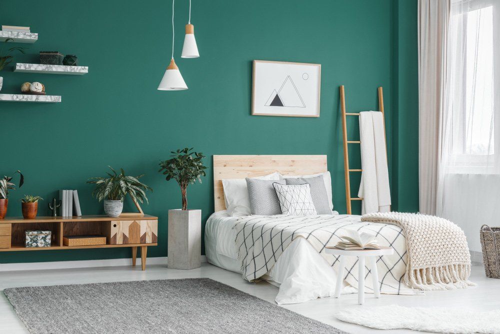 Bed With Wood Headboard On Blue Wall — Furnishers in Alice Springs, NT