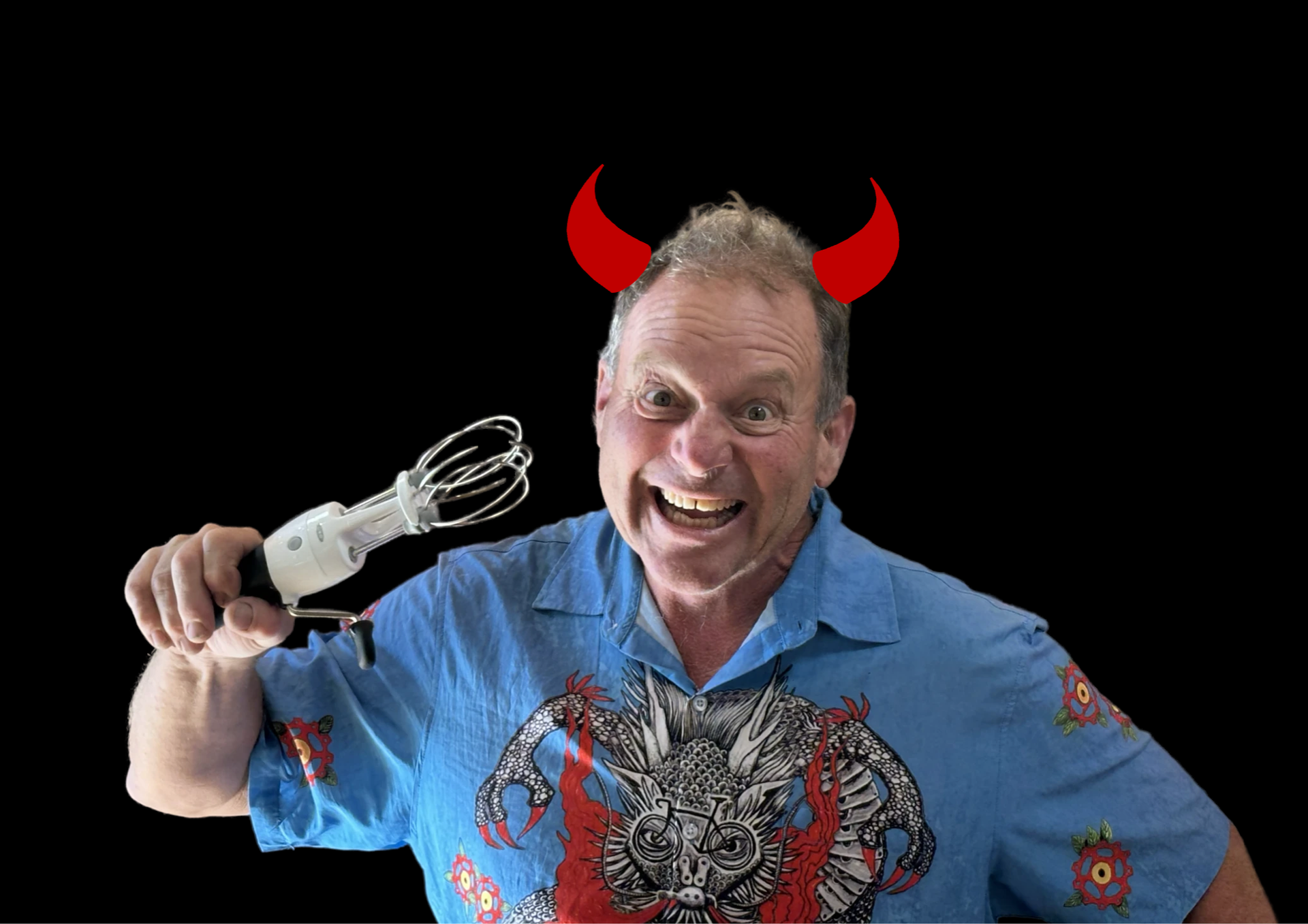Man wearing devil horns and a dragon shirt, holding a whisk, smiling against a black background.