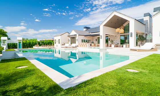 Custom inground pool with white patio and green lawn — Phoenix AZ pool contractor