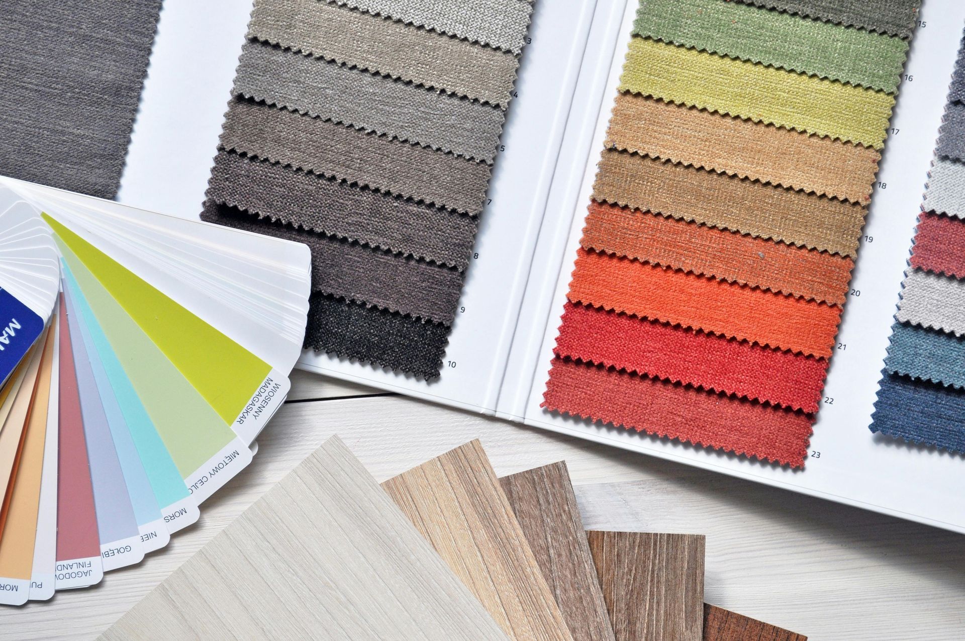 A fabric sample book with many different swatches in different colours