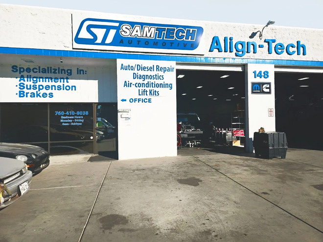 Exterior of Sam Tech Automotive shop, blue and white sign, specializing in alignment, suspension, brakes. | Samtech Automotive