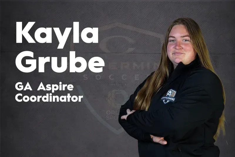 Kayla Grube, GA Aspire Coordinator, standing with arms crossed against a dark background.