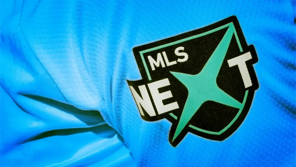 A blue Coppermine Soccer Club Jersey with a MLS NEXT logo on it