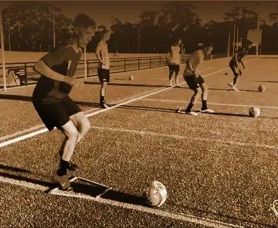 a group of young men are playing soccer on a field