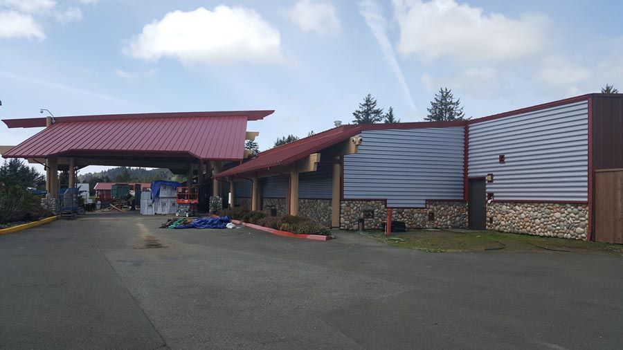 A large building with a red roof and a blue sky in the background