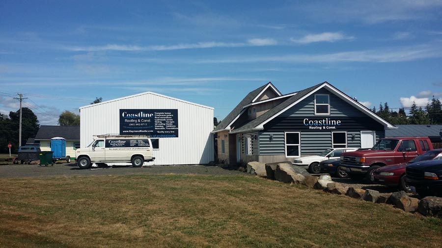 A white van is parked in front of a building.