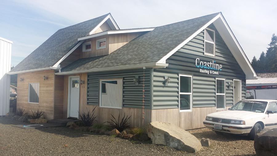 A white car is parked in front of a building that says crashine