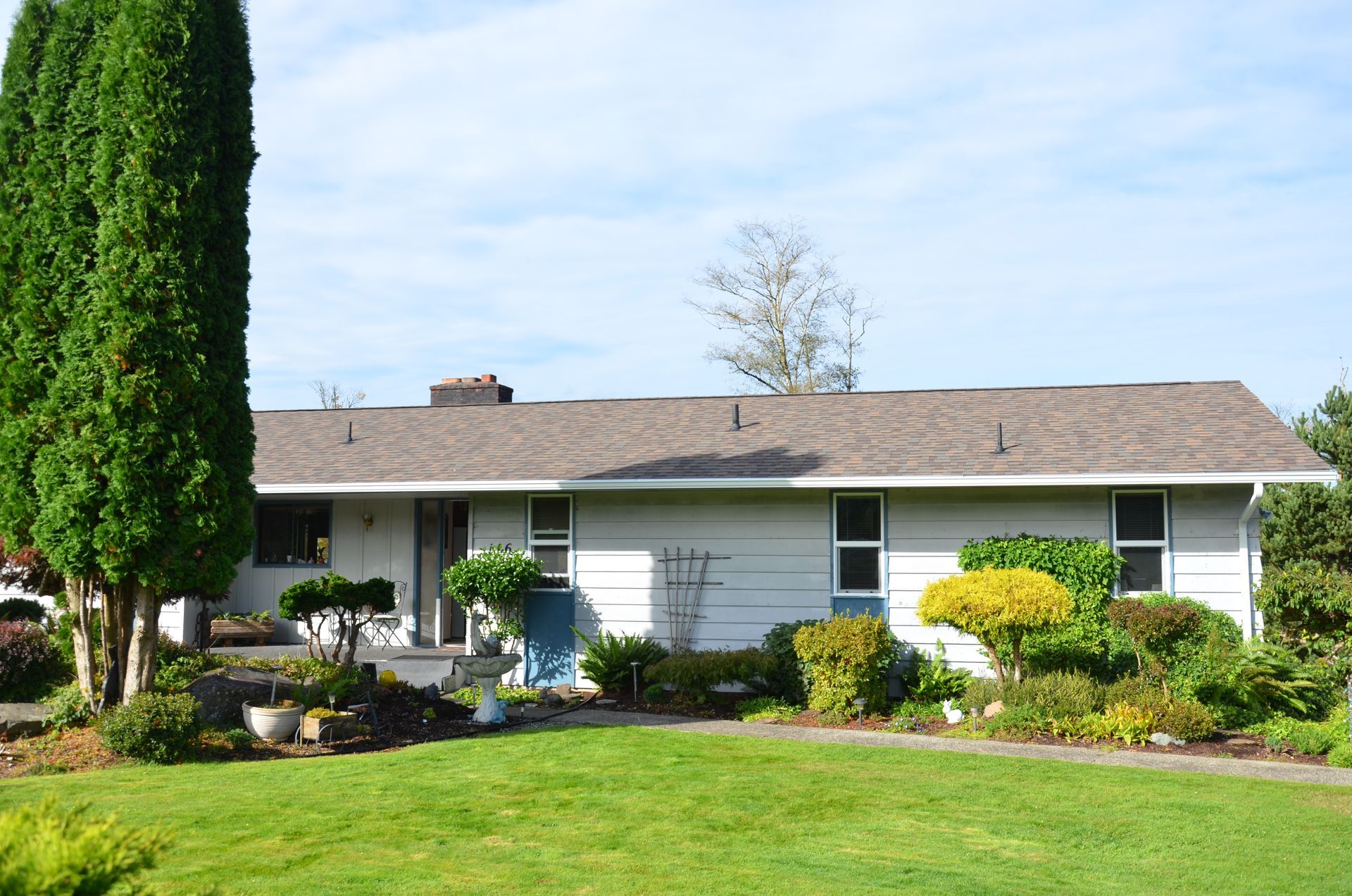 A house with a large lawn in front of it
