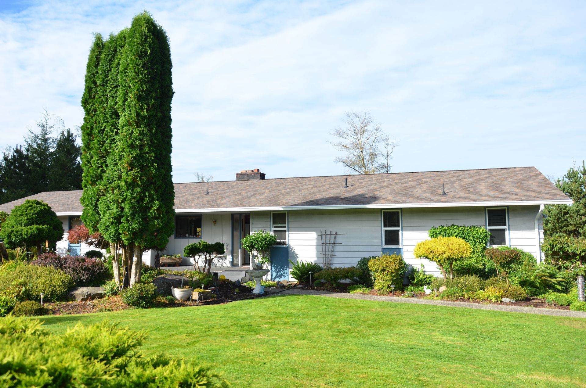 A white house with a large lawn in front of it