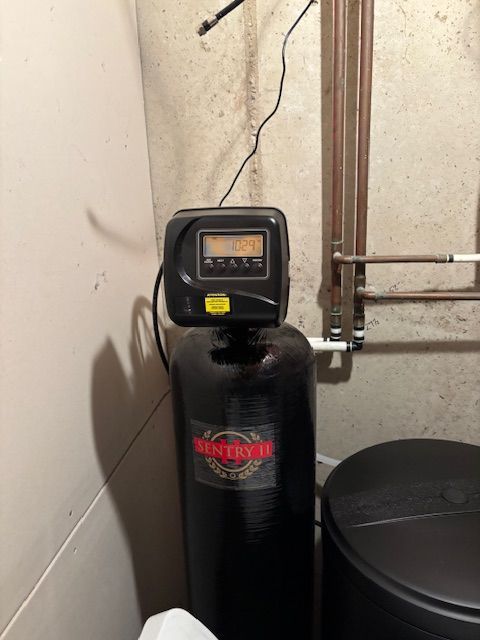 Water softener system in a basement setting with digital display.