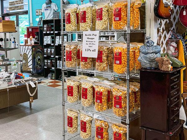 A shelf filled with bags of popcorn in a store.