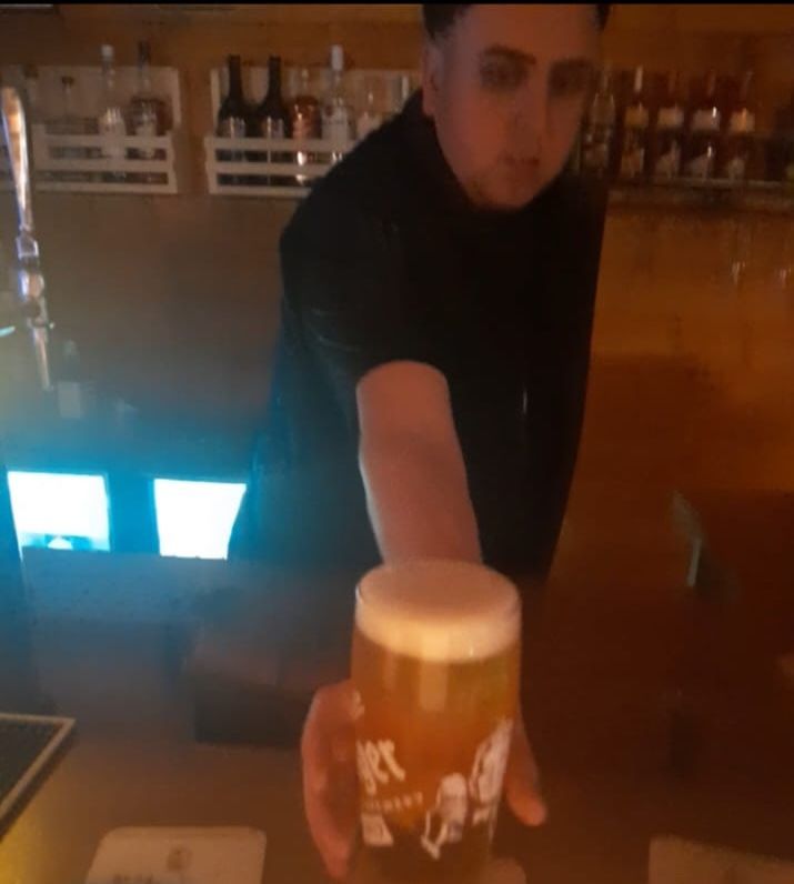 The Clubhouse Lounge at Delph Bank Touring Park being served by a member of the family owned park.