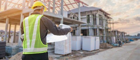 Concrete Contractor — Worker at House Building Construction Site in Windsor, CO