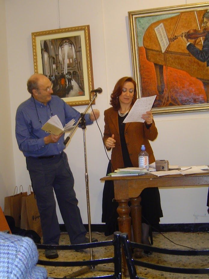 A man and a woman are standing in front of a microphone