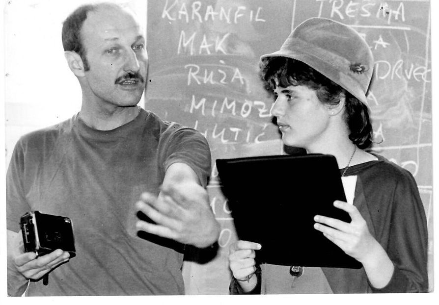 A man and a woman are standing in front of a blackboard that says karanfil