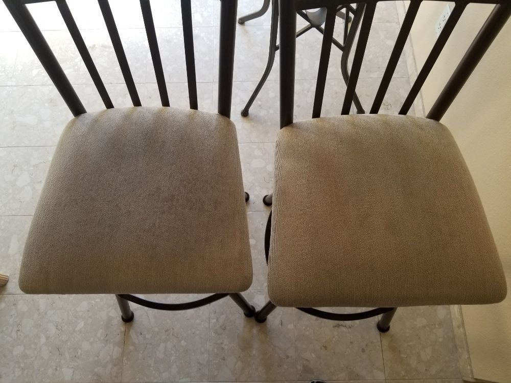 Two chairs are sitting next to each other on a tiled floor