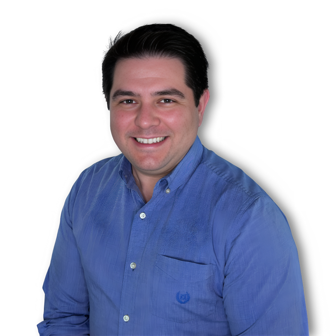 A man in a blue shirt is smiling for the camera