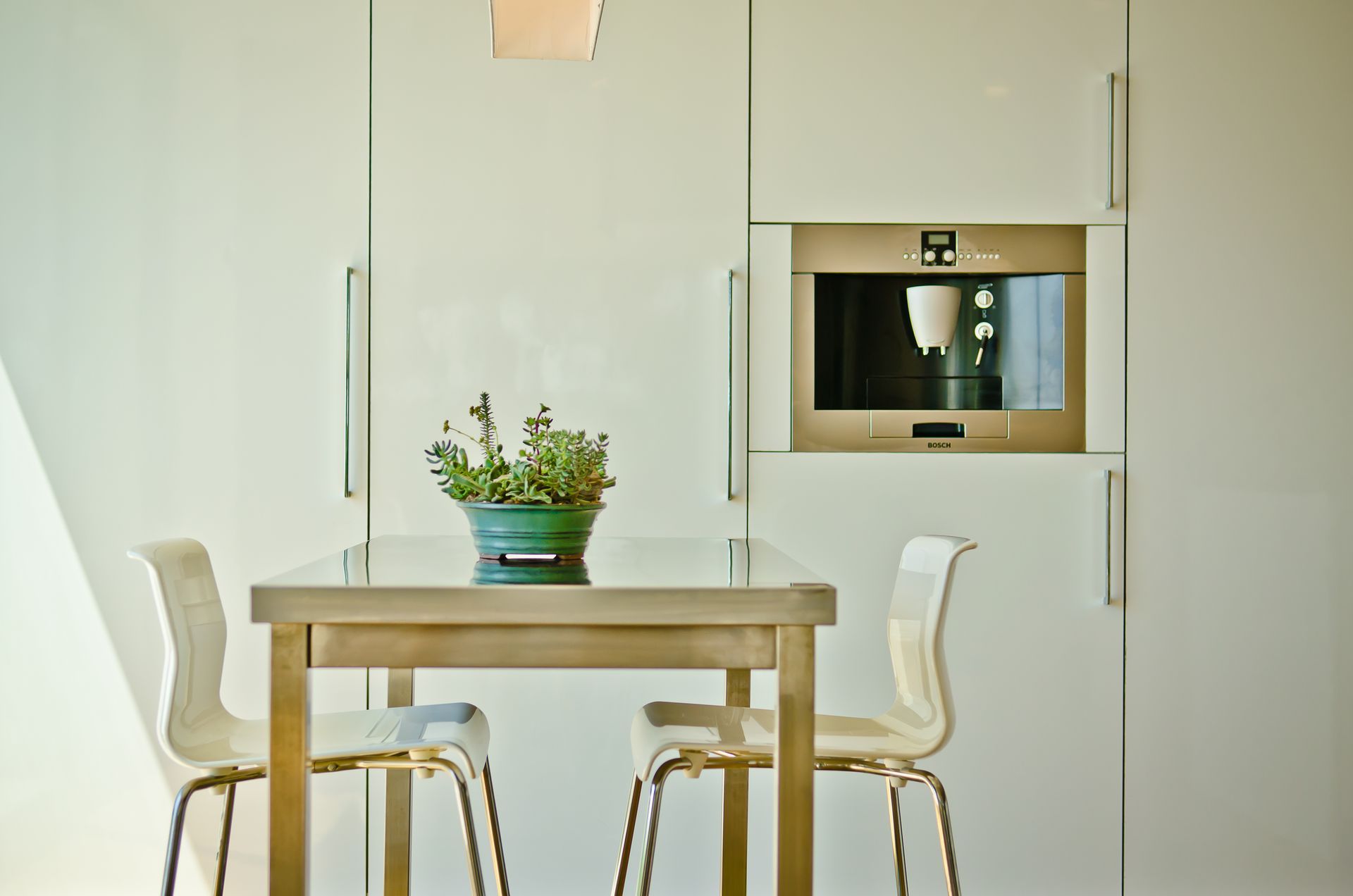A kitchen with a table and chairs and a microwave