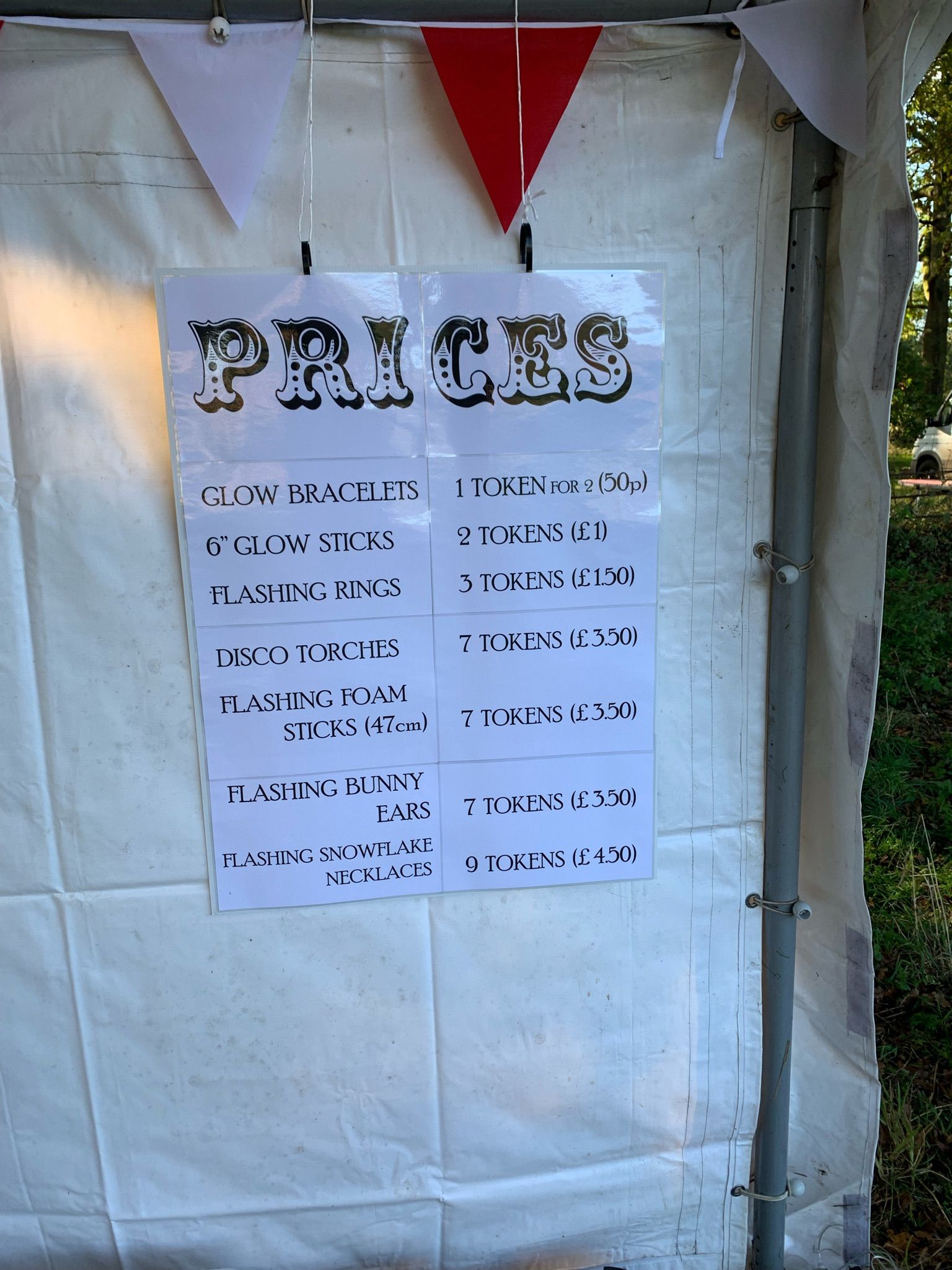 Sign on white tent, labeled 